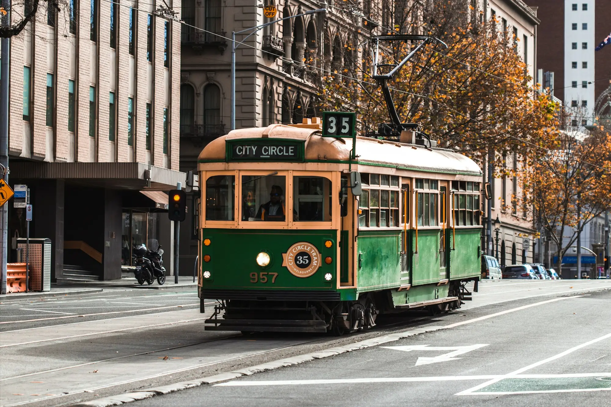 Green and yellow Melbourne tram on a city street